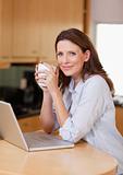Woman with laptop and a cup