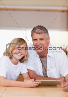 Man and his son using tablet