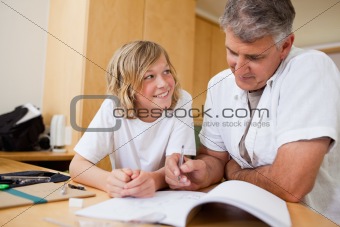 Boy doing homework with his father