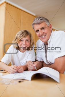 Boy getting help with homework from father