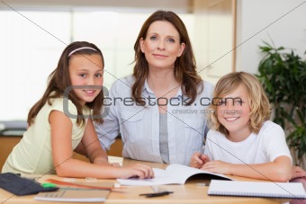 Woman helping her children with homework