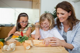 Woman making sandwiches with her children