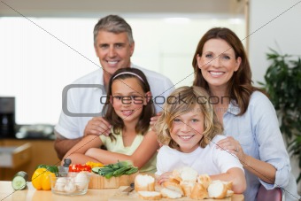Smiling family making sandwiches