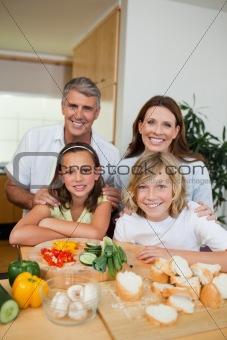 Happy family making sandwiches