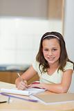 Smiling girl doing homework
