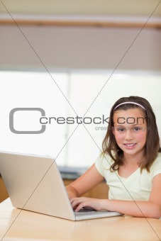 Girl using laptop in the kitchen