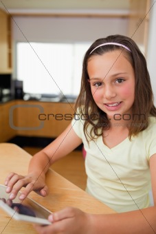 Girl using tablet in the kitchen