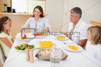 Mother serving dinner to family