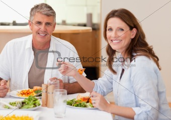 Smiling couple eating dinner