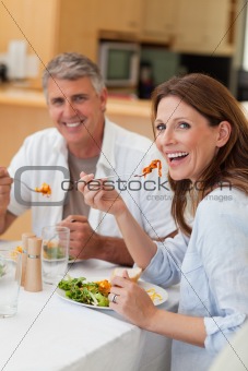 Happy couple eating dinner together