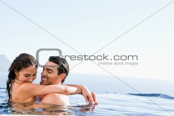Couple hugging in the pool