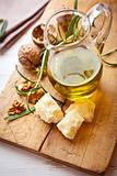 Jug of olive oil, grana padano cheese and walnuts