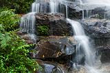 Smooth Waterfall and green leaves