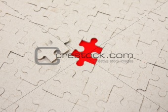 papper puzzle with  red piece missing