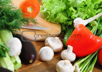 Fresh vegetables on the wooden background 