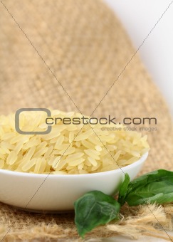 Uncooked rice in white bowl