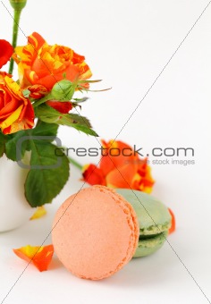 traditional french macarons with roses on the background