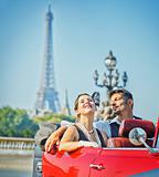 Happy smiling couple in a car. Romance in Paris.