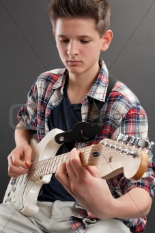 Teenager practicing electric guitar
