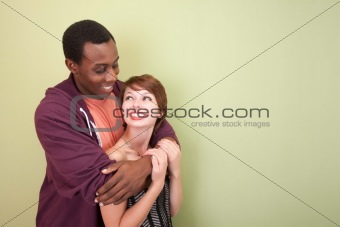 Loving mixed race couple look into each other's eyes