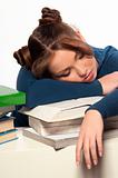 girl sleeping on a stack of books