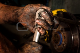 Hard working man with hands full of oil