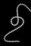 White pearls on the black velvet  background