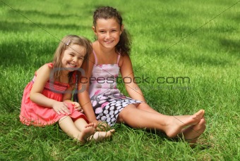 Two happy little girls having fun in the summer day