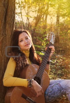 Beautiful brunette guitar player girl 