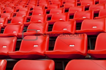 Red Empty plastic seats at stadium