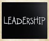 The word "Leadership" handwritten with white chalk on a blackboa