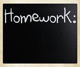 "Homework" handwritten with white chalk on a blackboard