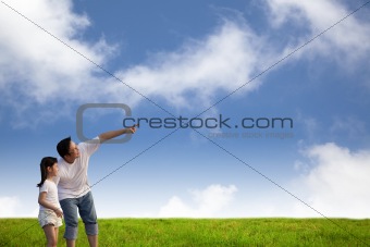 father  and little girl on the grass field
