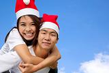 Young happy asian couple in Christmas hats