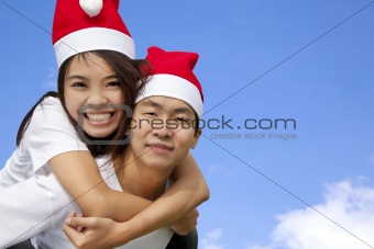 Young happy asian couple in Christmas hats