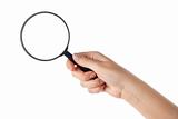Female hand holding the magnifying glass (isolated)