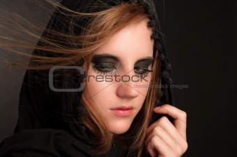 Black makeup and hood on a beutiful young girl