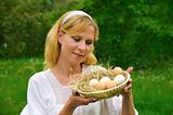 Happy young woman holding fresh eggs