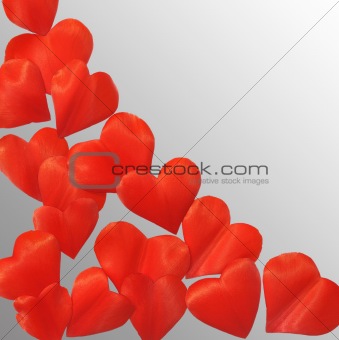 Petals in heart shape over gray background - frame. Clipping path included.