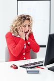 Oh no - shocked business woman in front of computer