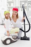 Cleaning day - woman and little girl with vacuum cleaner