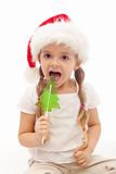 Christmas girl with fir tree shaped candy