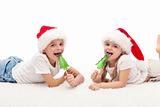 Happy kids with santa hats and candy