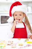 Little girl decorating christmas cookies