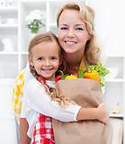 Little girl and woman with the groceries