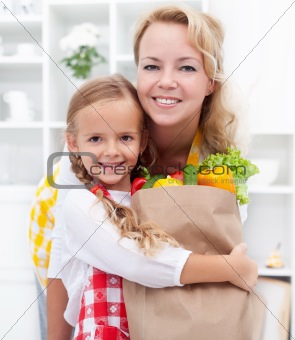 Little girl and woman with the groceries