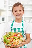 Happy boy with fresh salad - healthy nutrition