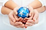 Adult and child hands holding christmas bauble