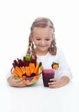 Little girl with fresh vegetables and juice
