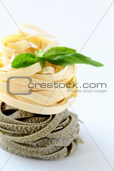 Italian pasta fettuccine nest  with basil